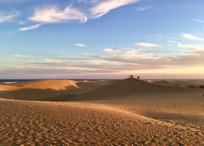 Scenic view of desert against sky during sunset