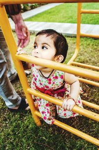 Baby girl on jungle gym