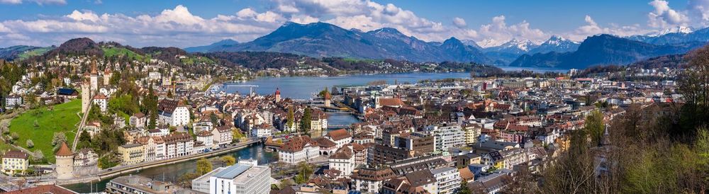 High angle view of city by bay against sky