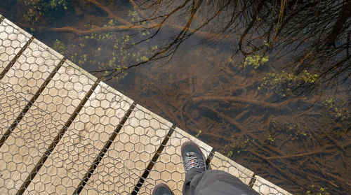 Diagonally split shot with wooden boardwalk and water reflections. glenorchy, new zealand