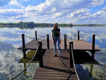 Wooden pier on lake against sky