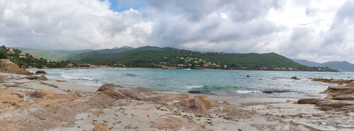 Panoramic view of sea and mountains against sky