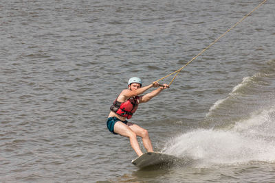 Man kite boarding in river