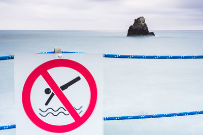 Sea stack in front of defocused sign