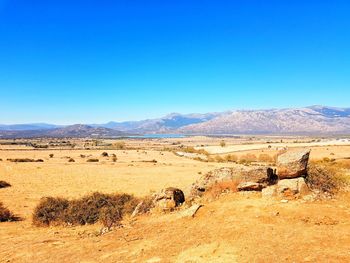 Scenic view of landscape against blue sky