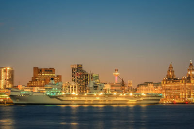 Illuminated buildings in city at waterfront