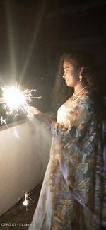 Low angle view of woman standing at night