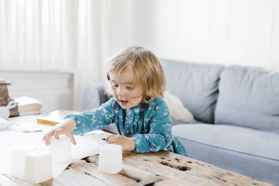 Boy playing on table at home