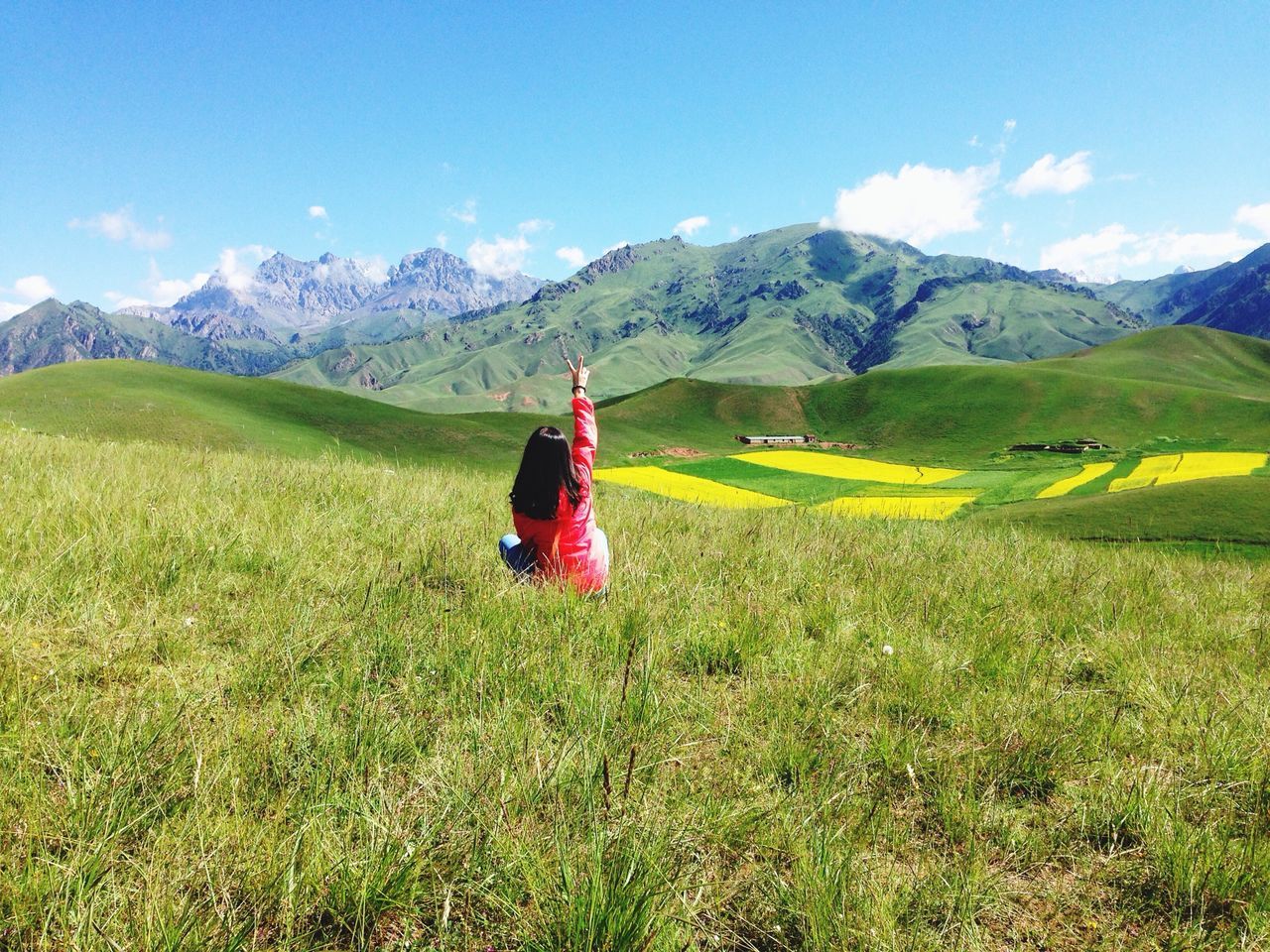 mountain, grass, landscape, mountain range, sky, tranquil scene, grassy, tranquility, field, red, scenics, beauty in nature, non-urban scene, nature, cloud, remote, cloud - sky, green color, day, idyllic