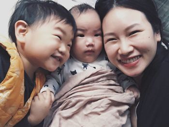 Close-up of happy mother with sons