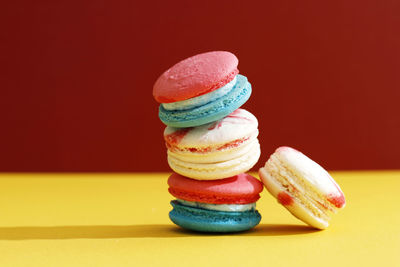 Stacked macaroon on red background, copy space for text