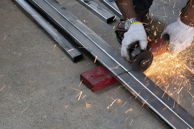 Low section of man working on metal