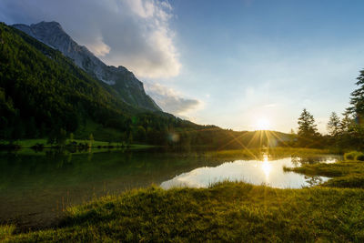 Scenic view of lake and mountains against sky