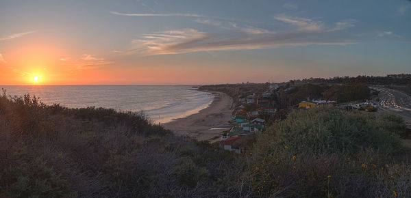 View of calm beach at sunset