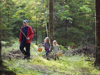 Father with daughters picking mushrooms