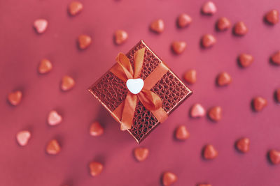 Red gift box on the background of hearts for valentine's day