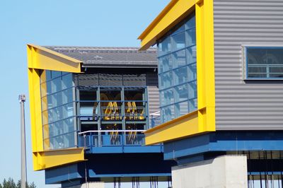 Low angle view of yellow building against clear sky