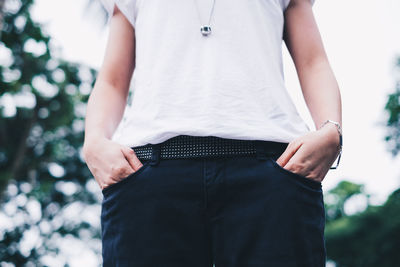 Midsection of woman standing against blurred background