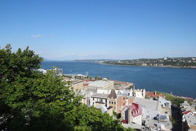 High angle view of cityscape and sea against sky