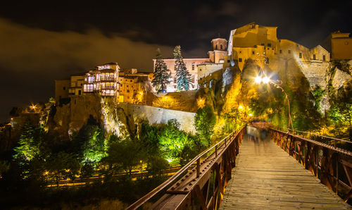 Illuminated buildings against sky at night