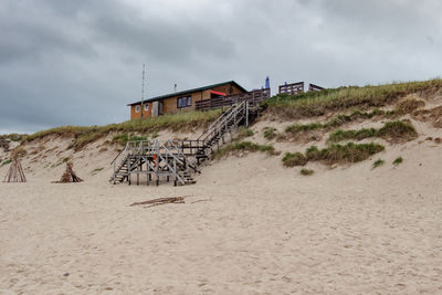 Built structure on beach against sky