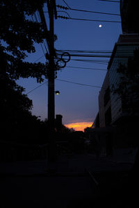 Low angle view of silhouette trees against sky at sunset