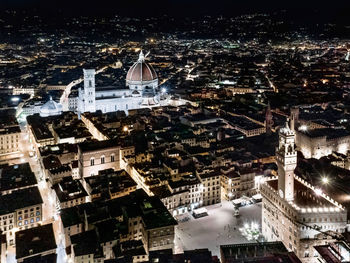 Aerial view of illuminated buildings in city