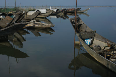 Boats moored in lake against sky
