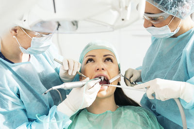 Dentists treating patient in hospital