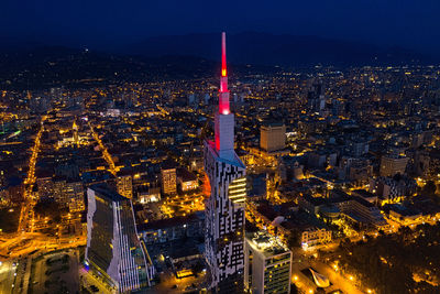 High angle view of city lit up at night