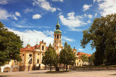 View of buildings on loreto square on hradcany, prague against cloudy sky.