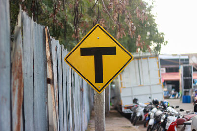 Close-up of road sign against trees