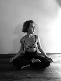 Young woman sitting on floor