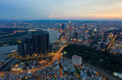 High angle view of city lit up at night