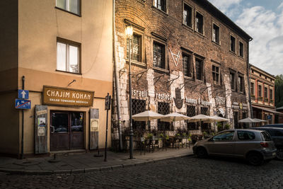 Cars on street by buildings in city