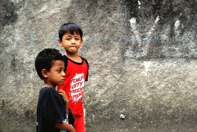 Boys standing against wall