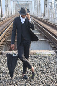 Full length of man walking on railroad track