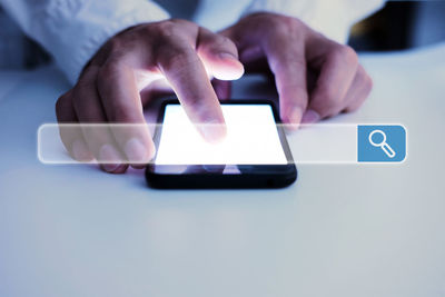 Midsection of man using mobile phone