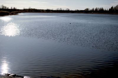 Scenic view of lake against sky during winter