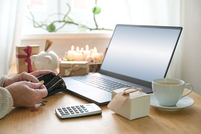 Cropped hand using laptop on table