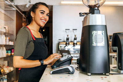 Young woman working in kitchen