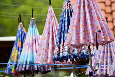 Multi colored umbrellas hanging on clothesline