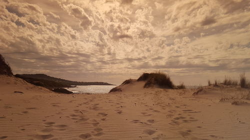 Scenic view of beach against sky during sunset