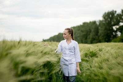 Young woman standing on field