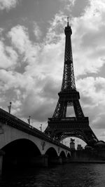 Low angle view of bridge against cloudy sky