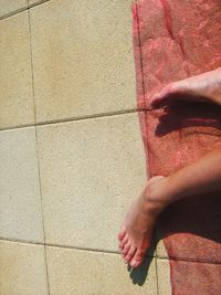 Low section of woman standing on tiled floor