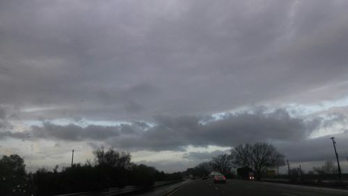 Road passing through dramatic sky