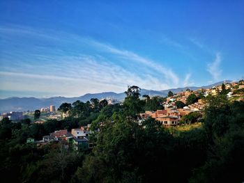 View of cityscape against cloudy sky