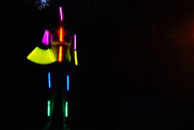 Close-up of illuminated lights over black background