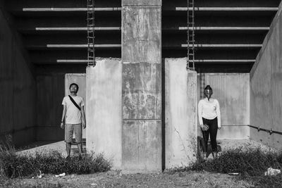 Full length of young man standing against wall